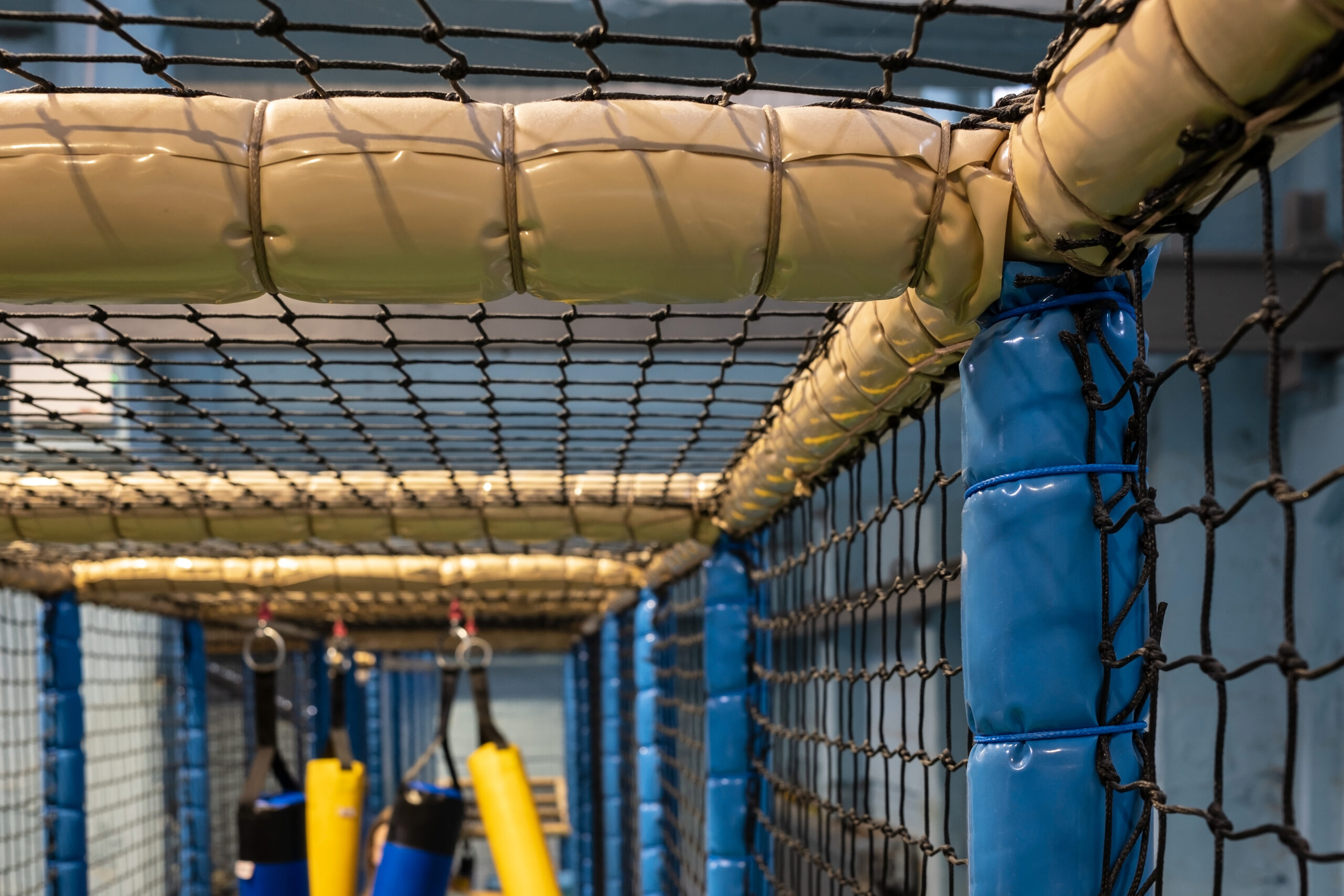 Safety netting installation on an elevated structure