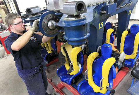 Maintenance mechanic servicing attraction machinery
